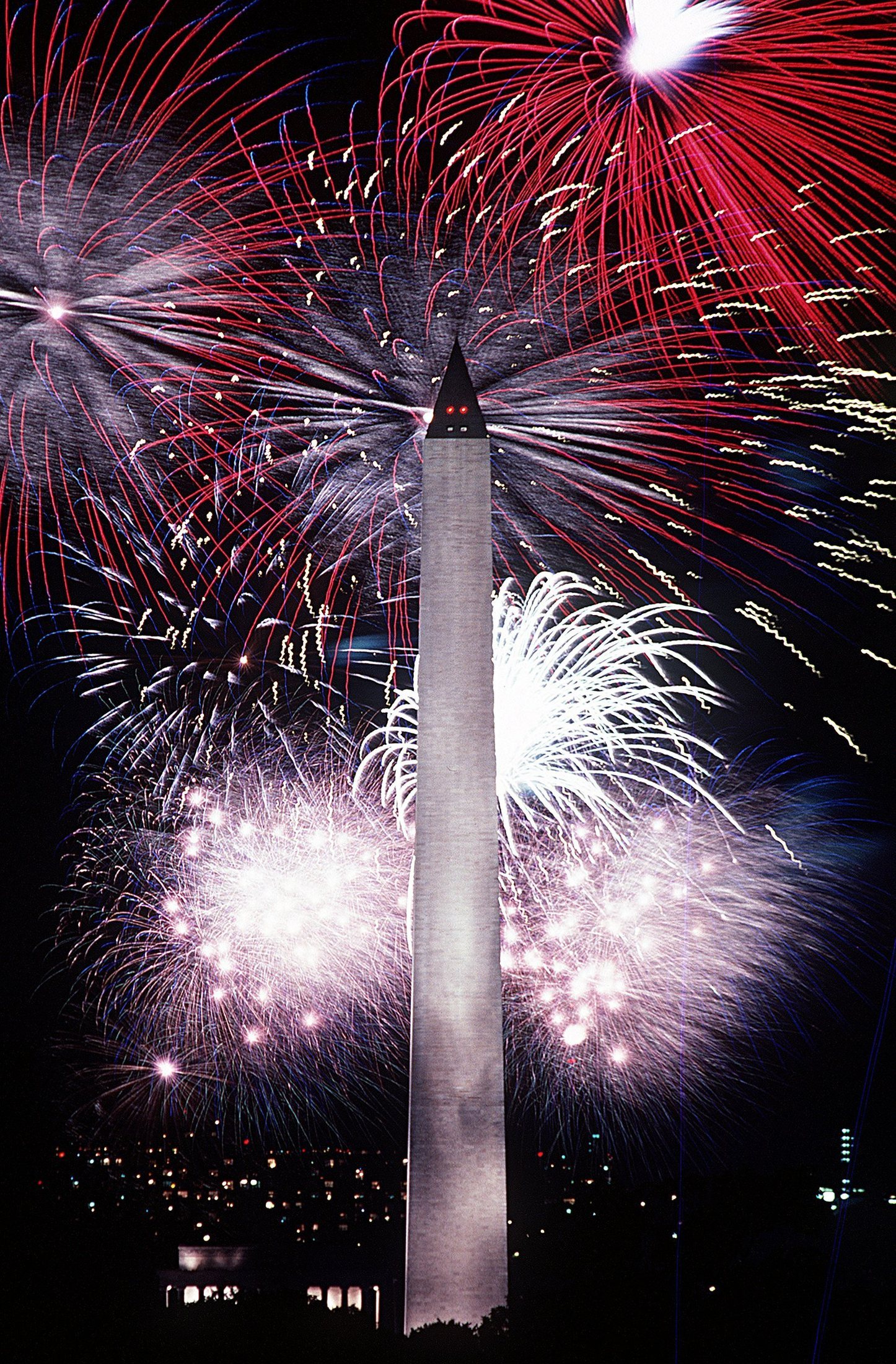 Bright fireworks lighting up the sky over the Washington Monument on the Fourth of July