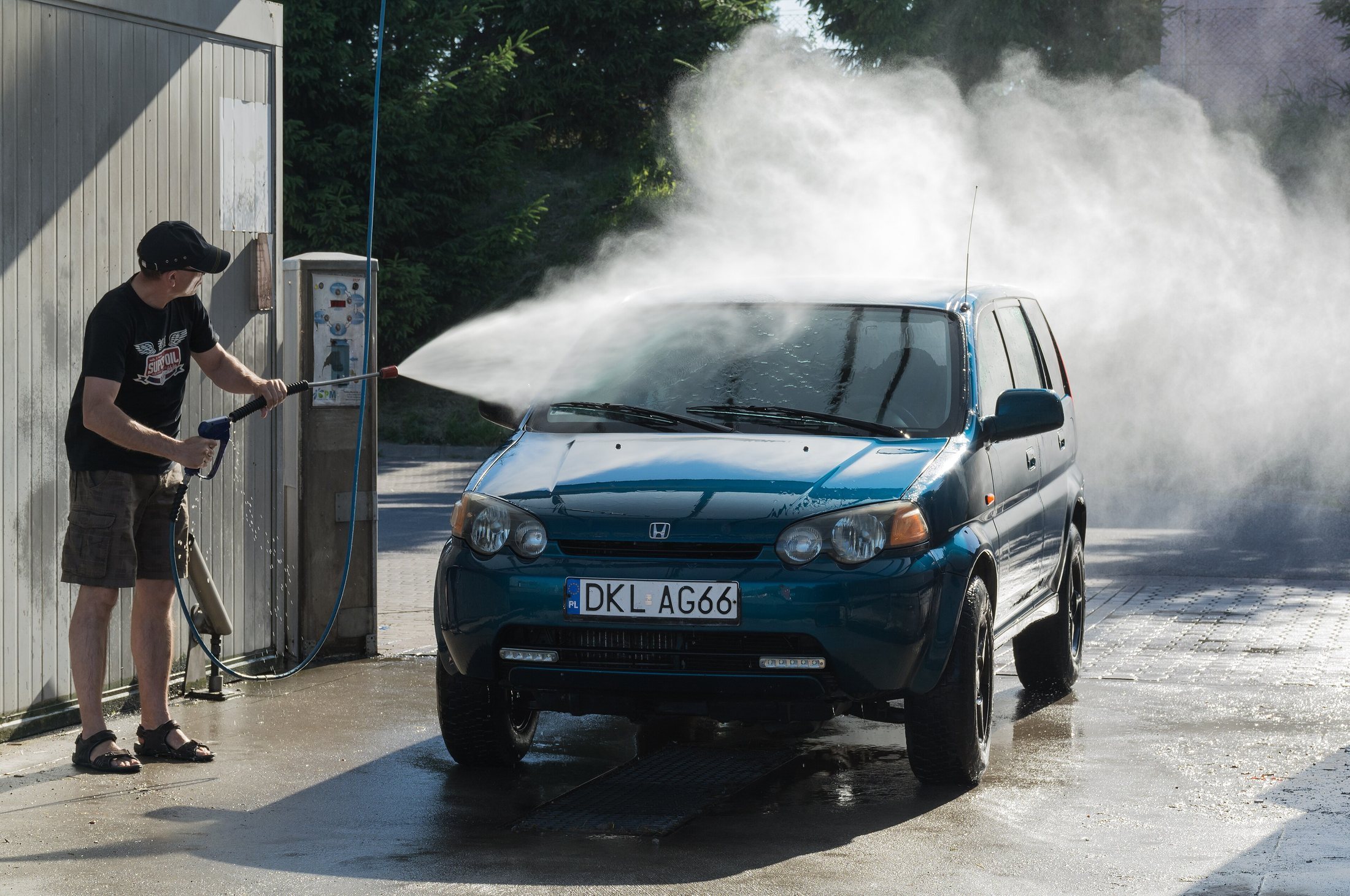 A car going through a car wash with water spraying around it.