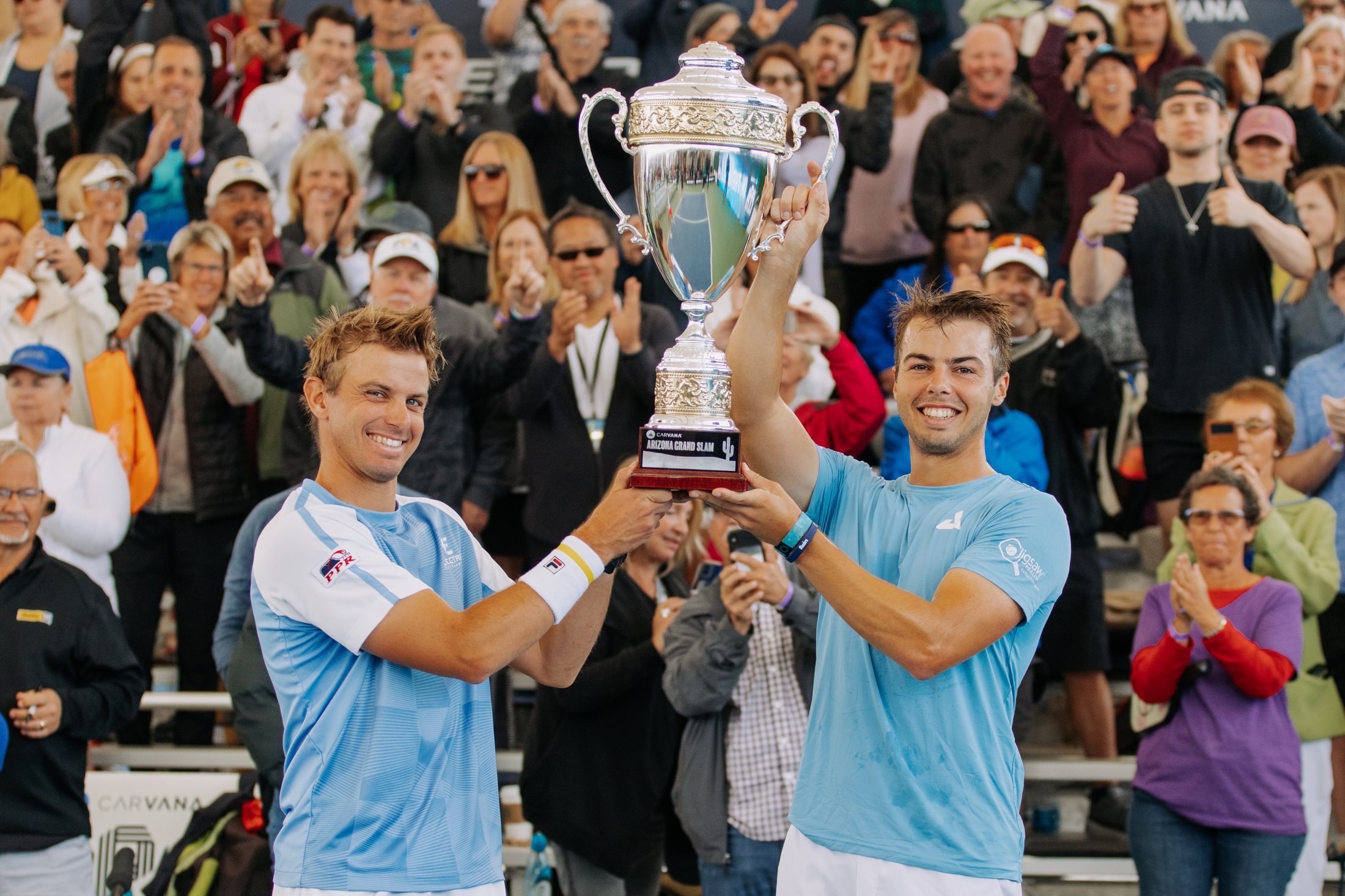 Brothers Ben Johns and Collin Johns celebrating after winning a professional doubles pickleball tournament in 2023